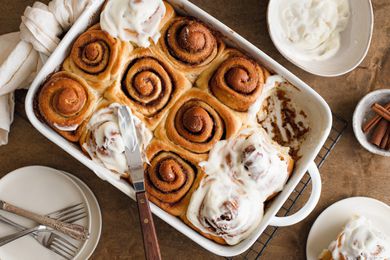 Sourdough Discard Cinnamon Rolls in a Casserole Dish with Some Glazed with Cream Cheese Frosting