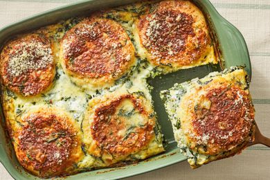 Serving of spinach florentine breakfast casserole lifted from a casserole dish