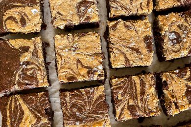 Chocolate Tahini Brownies with Flaky Salt on a Piece of Parchment Paper