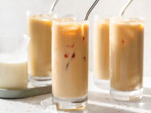Glasses of Thai Iced Tea and a Creamer Filled With Milk
