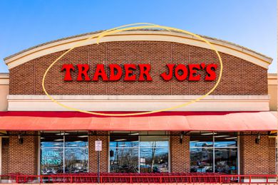 Trader Joe's storefront with a yellow circle illustration over the logo