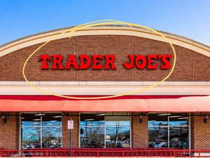 Trader Joe's storefront with a yellow circle illustration over the logo