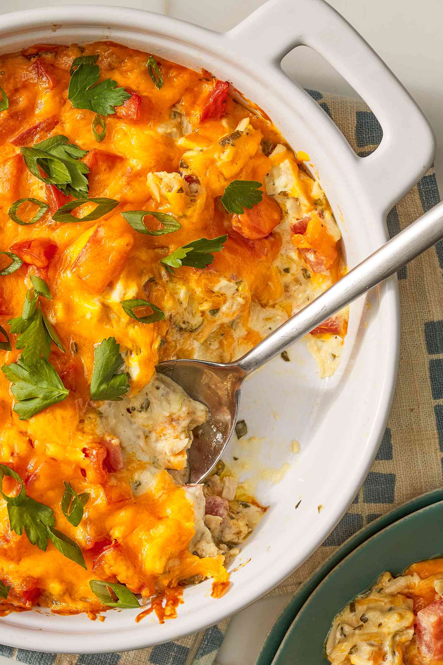 Close-up: Tuna melt dip in a casserole dish with a stainless steel spoon