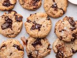 The best vegan chocolate chip cookies with flaky salt on top on a baking sheet.