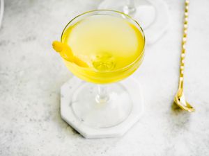 White Negroni Garnished with a Lemon Peel 