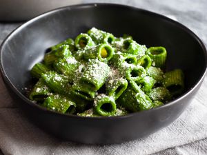 Swiss chard, lemon, and parmesan pasta heaped in a low bowl.