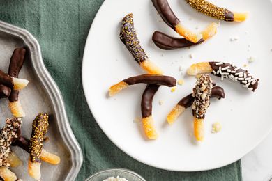 Plate of Chocolate Covered Orange Peels Next to a Tray with More