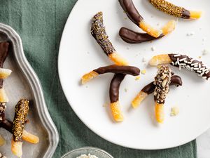 Plate of Chocolate Covered Orange Peels Next to a Tray with More