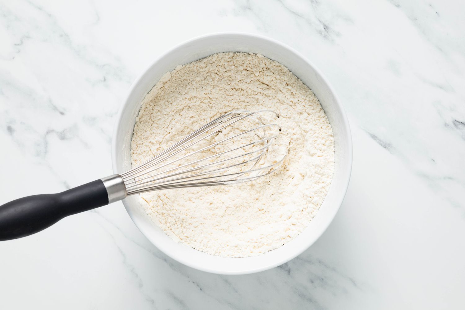 Bowl of dry ingredients whisked together for marble brownies recipe